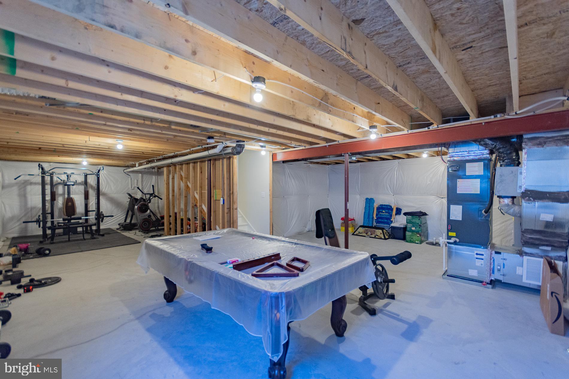 236 Surplus Road Inwood, WV 25428 - Photo 56 of 72 a room with gym equipment and a table