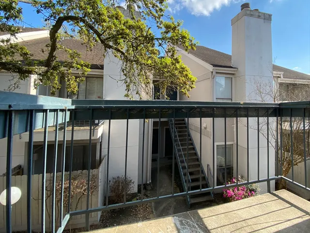 a view of balcony with wooden floor and fence