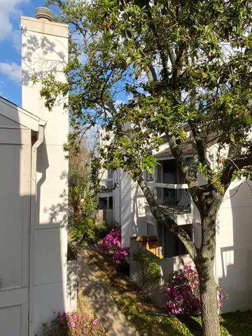 a view of a house with a tree