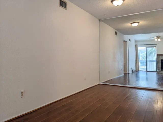 a view of a room with wooden floor