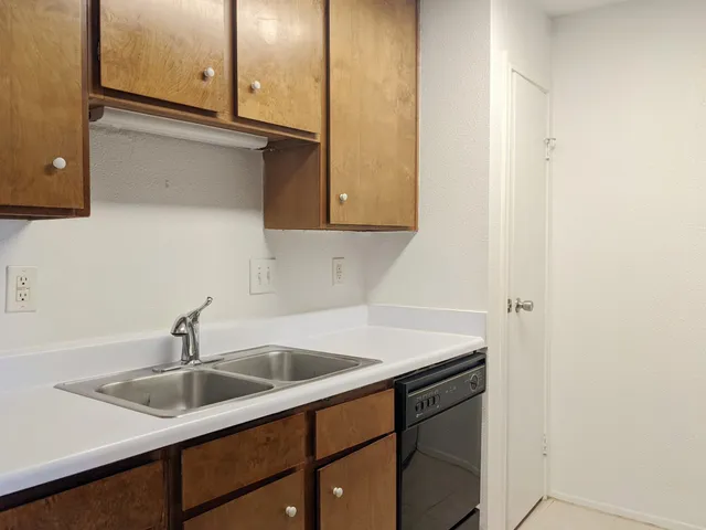 a kitchen with a sink and cabinets