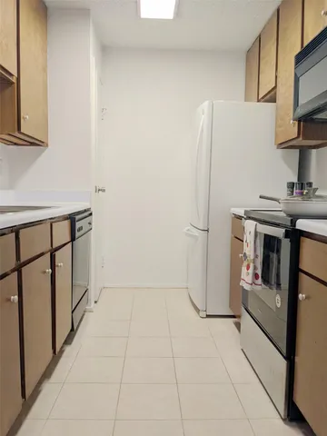 a kitchen with stainless steel appliances a refrigerator and a stove