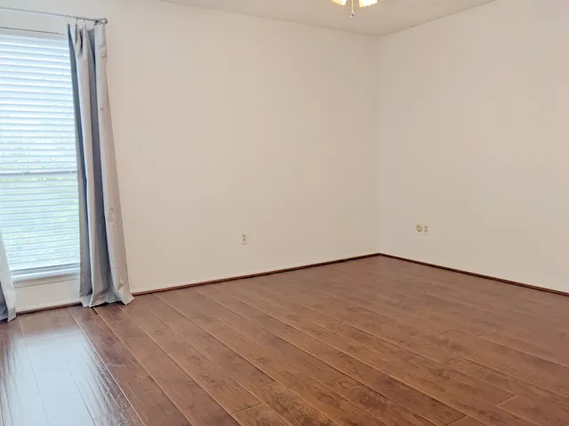 a view of an empty room and wooden floor