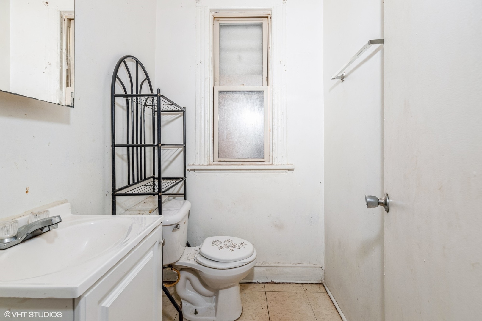 2022 West 68th Street Chicago, IL 60636 - Photo 4 of 10 a bathroom with a toilet sink and mirror