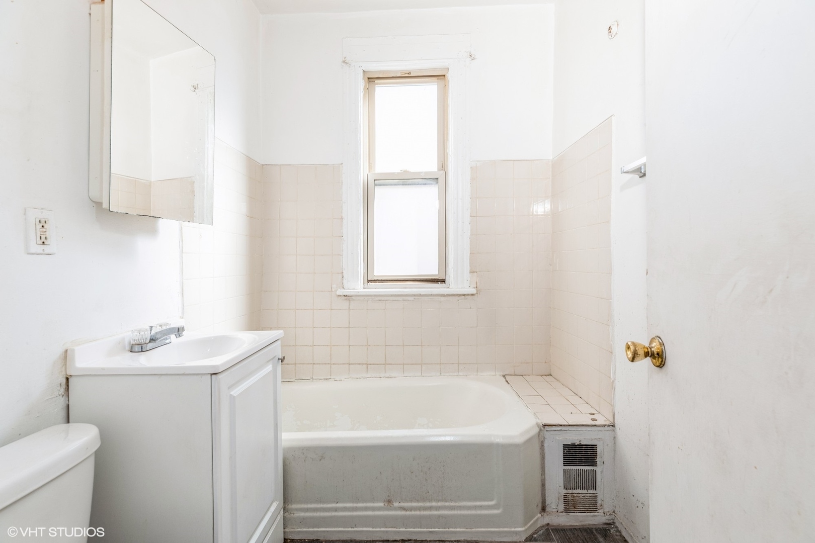2022 West 68th Street Chicago, IL 60636 - Photo 7 of 10 a white bath tub sitting next to a white sink and a toilet