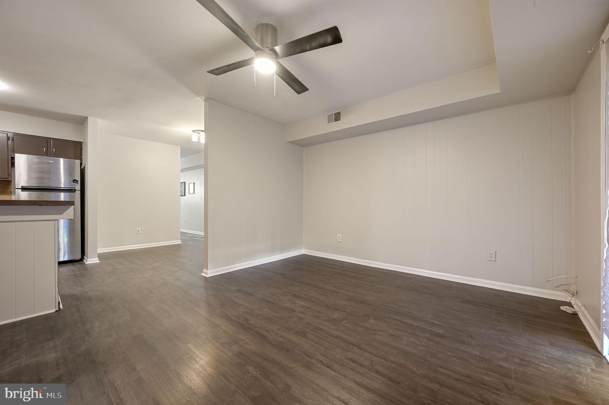 33 Spruance Road Dover, DE 19901 - Photo 11 of 20 an empty room with wooden floor ceiling fan and windows