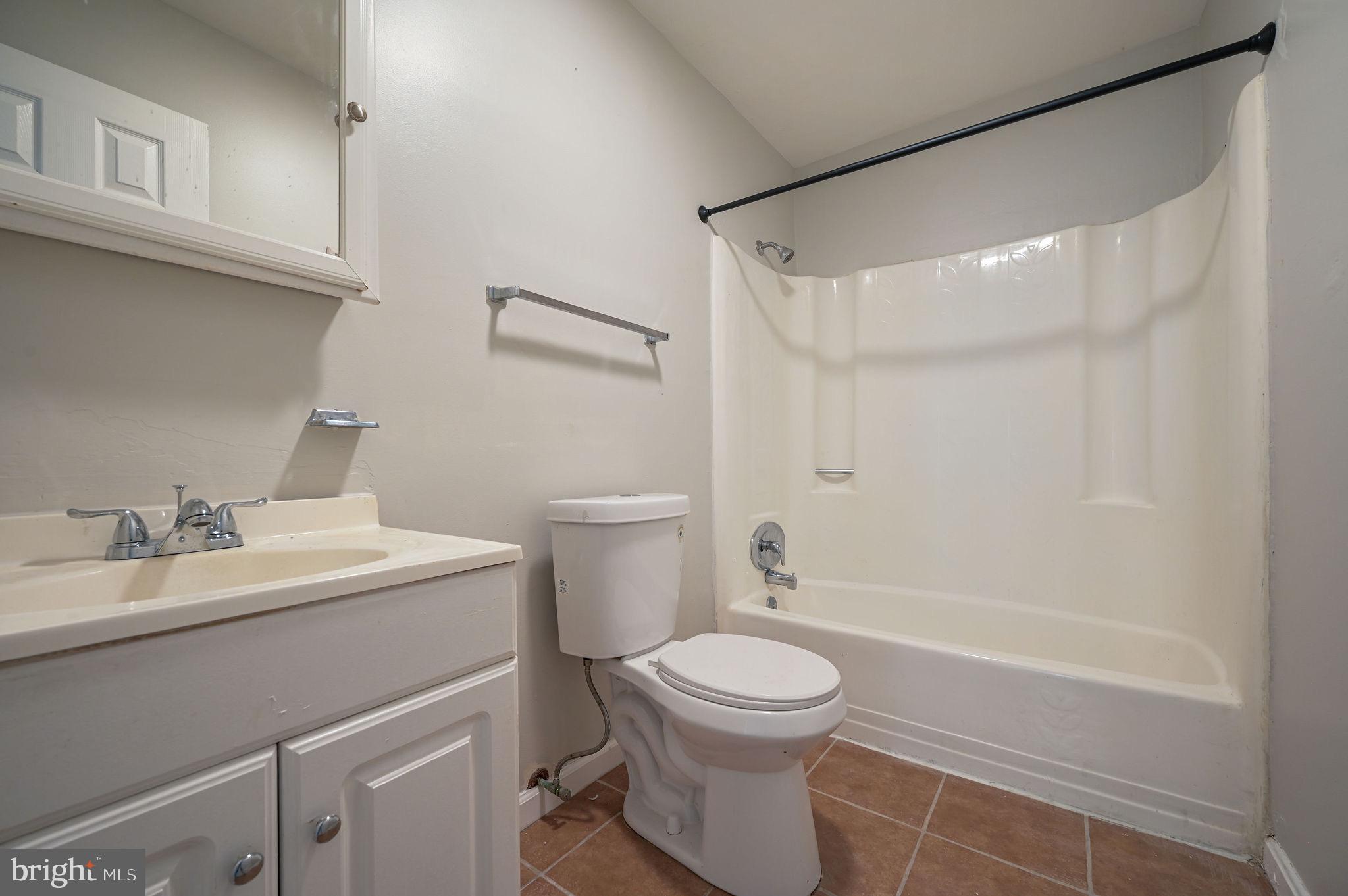 33 Spruance Road Dover, DE 19901 - Photo 18 of 20 a bathroom with a sink a toilet and shower