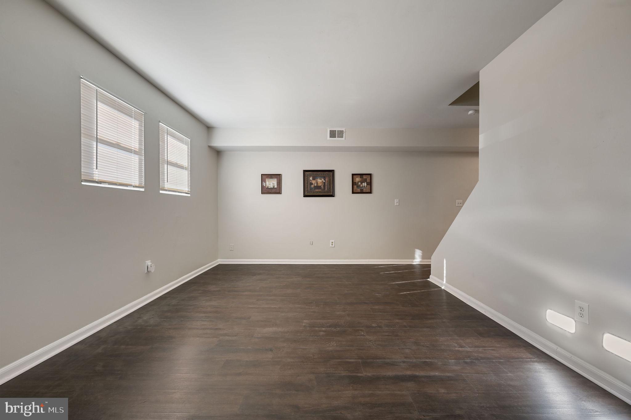 33 Spruance Road Dover, DE 19901 - Photo 2 of 20 a view of an empty room with wooden floor and a window