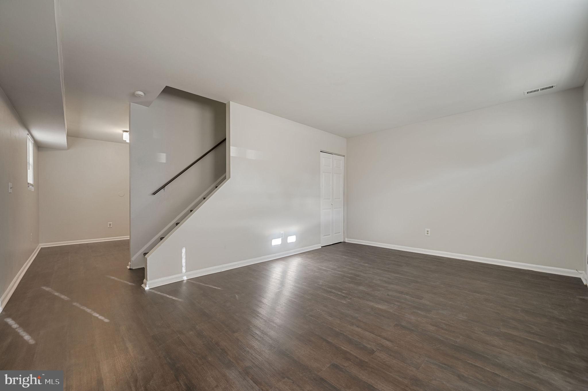 33 Spruance Road Dover, DE 19901 - Photo 4 of 20 a view of an empty room with wooden floor