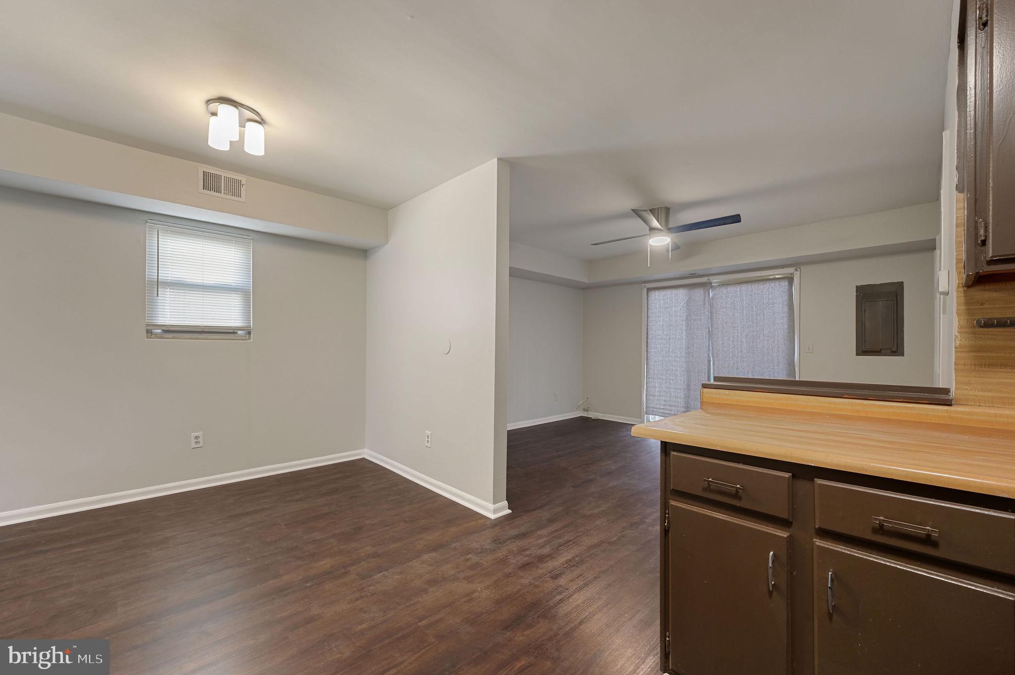 33 Spruance Road Dover, DE 19901 - Photo 8 of 20 a view of a livingroom with wooden floor and a ceiling fan