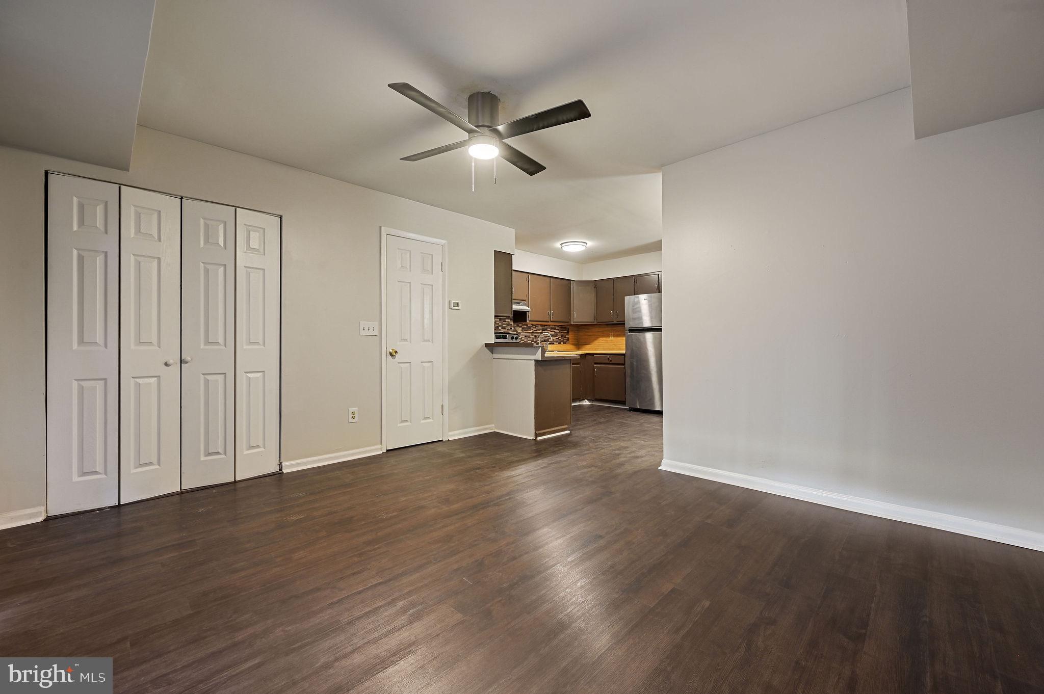 33 Spruance Road Dover, DE 19901 - Photo 10 of 20 an empty room with wooden floor cabinet and windows