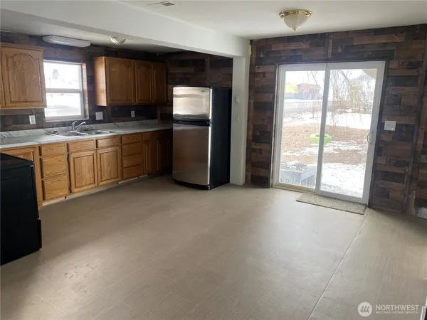 a kitchen with stainless steel appliances granite countertop a refrigerator a sink a stove a microwave a sink and cabinets