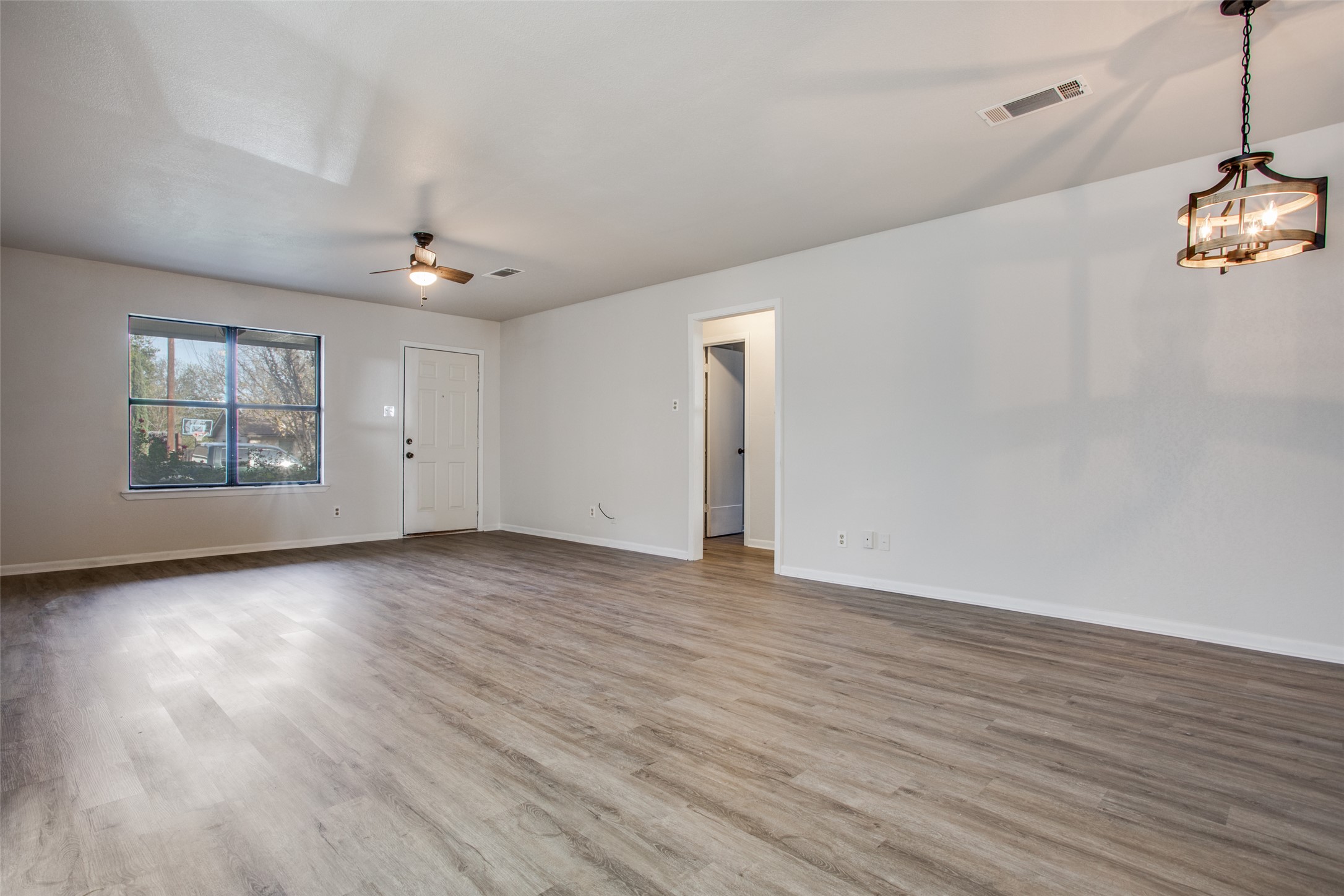2212 Rifle Bend Drive Georgetown, TX 78626 - Photo 2 of 15 wooden floor in an empty room with a window