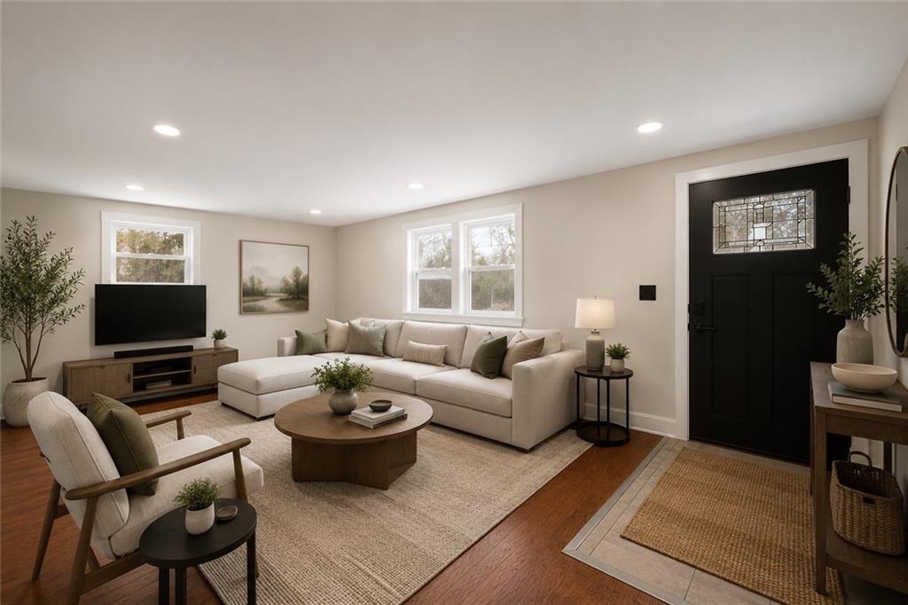 933 Boyce Road Bridgeville, PA 15017 - Photo 7 of 36 a living room with furniture a flat screen tv and a large window