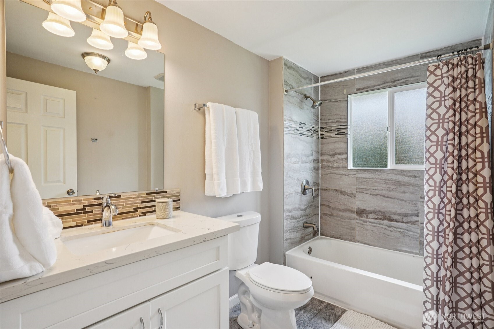 3709 Northeast 9th Court Renton, WA 98056 - Photo 12 of 21 a bathroom with a sink a toilet a mirror a bathtub and shower