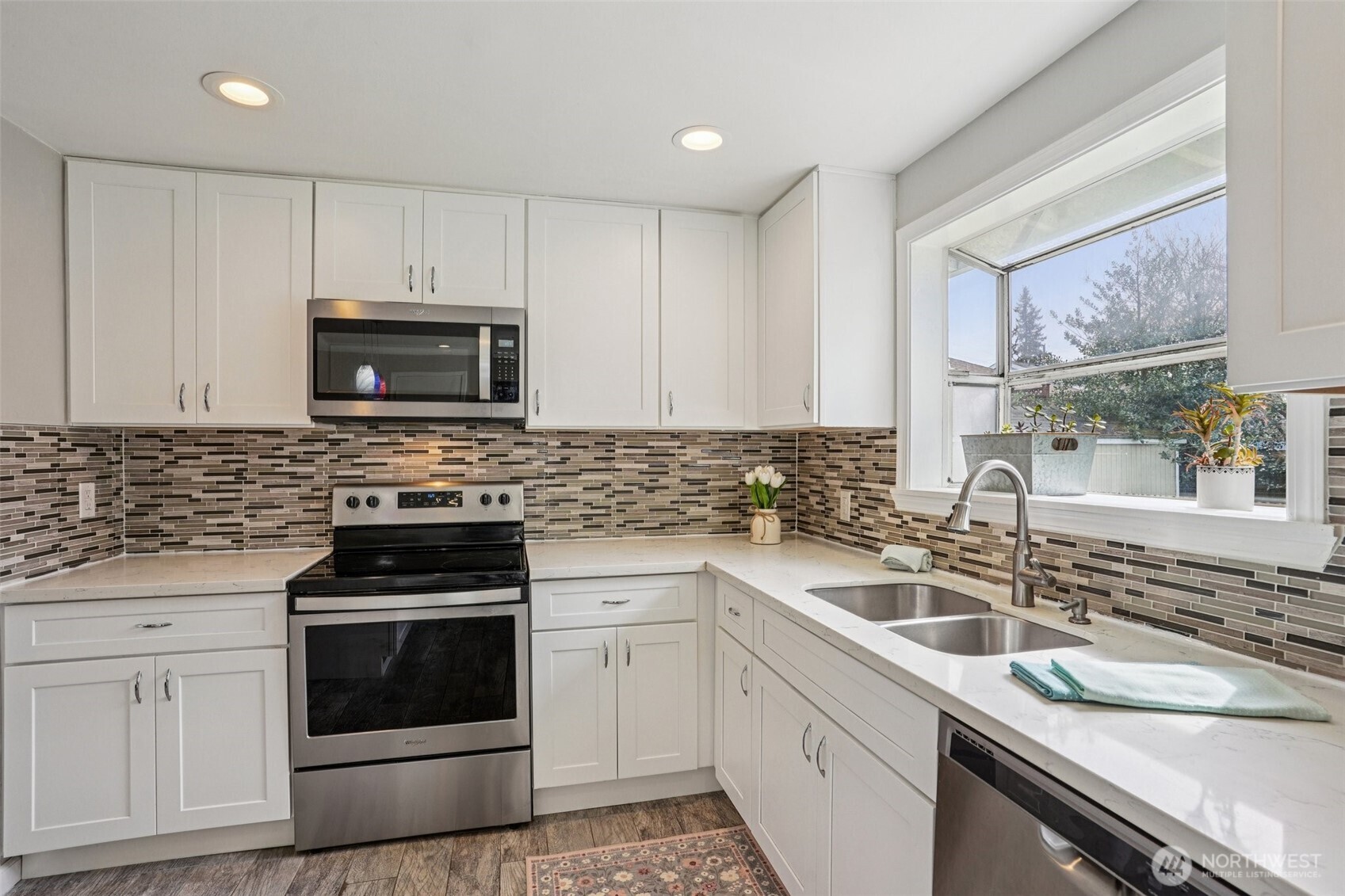 3709 Northeast 9th Court Renton, WA 98056 - Photo 3 of 21 a kitchen with granite countertop a sink a stove a microwave and wooden cabinets