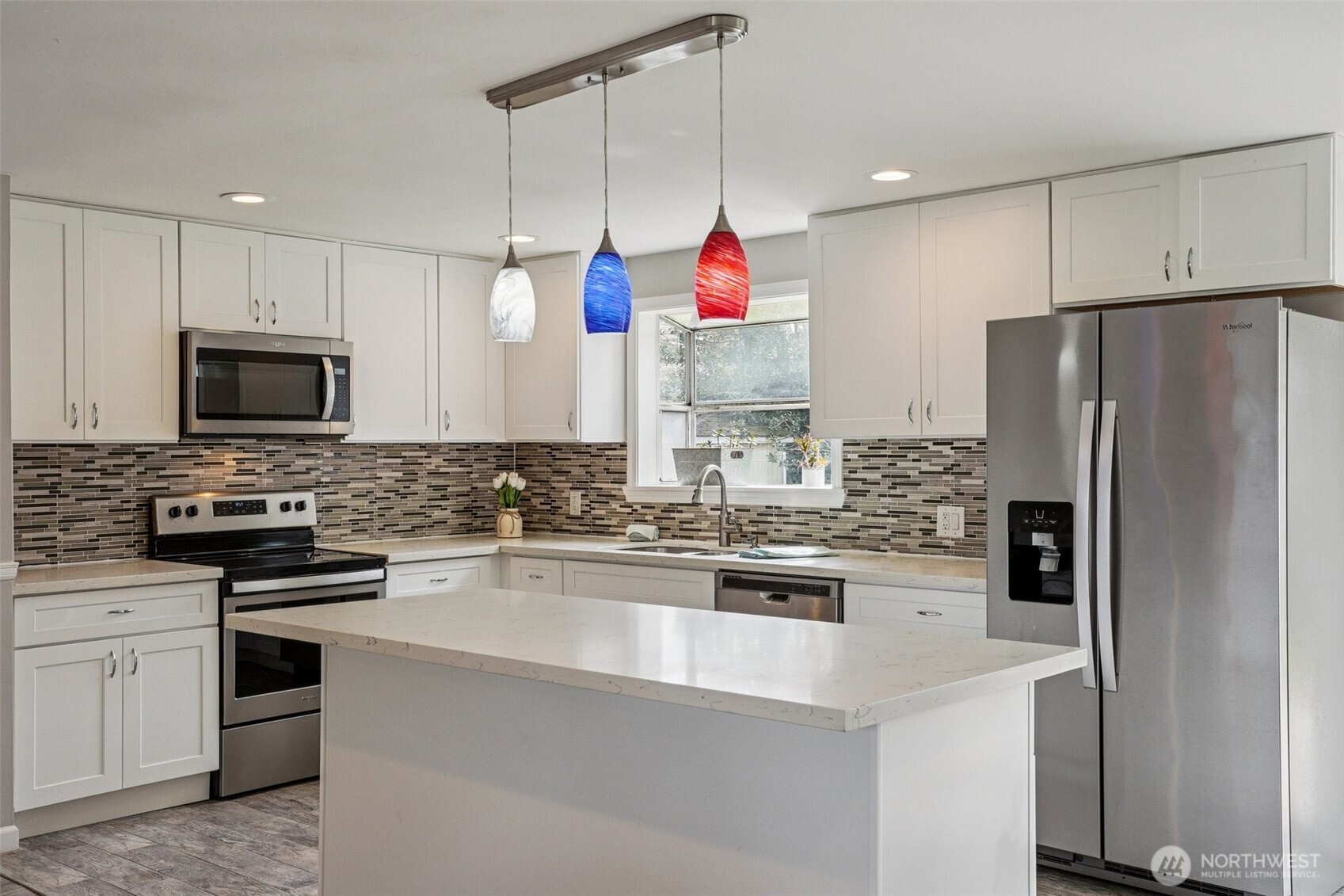 3709 Northeast 9th Court Renton, WA 98056 - Photo 4 of 21 a kitchen with kitchen island granite countertop stainless steel appliances and refrigerator