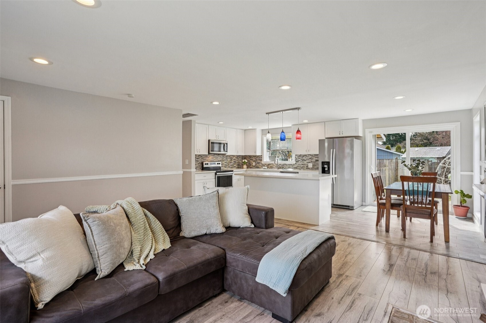 3709 Northeast 9th Court Renton, WA 98056 - Photo 8 of 21 a living room with furniture and a dining table with wooden floor