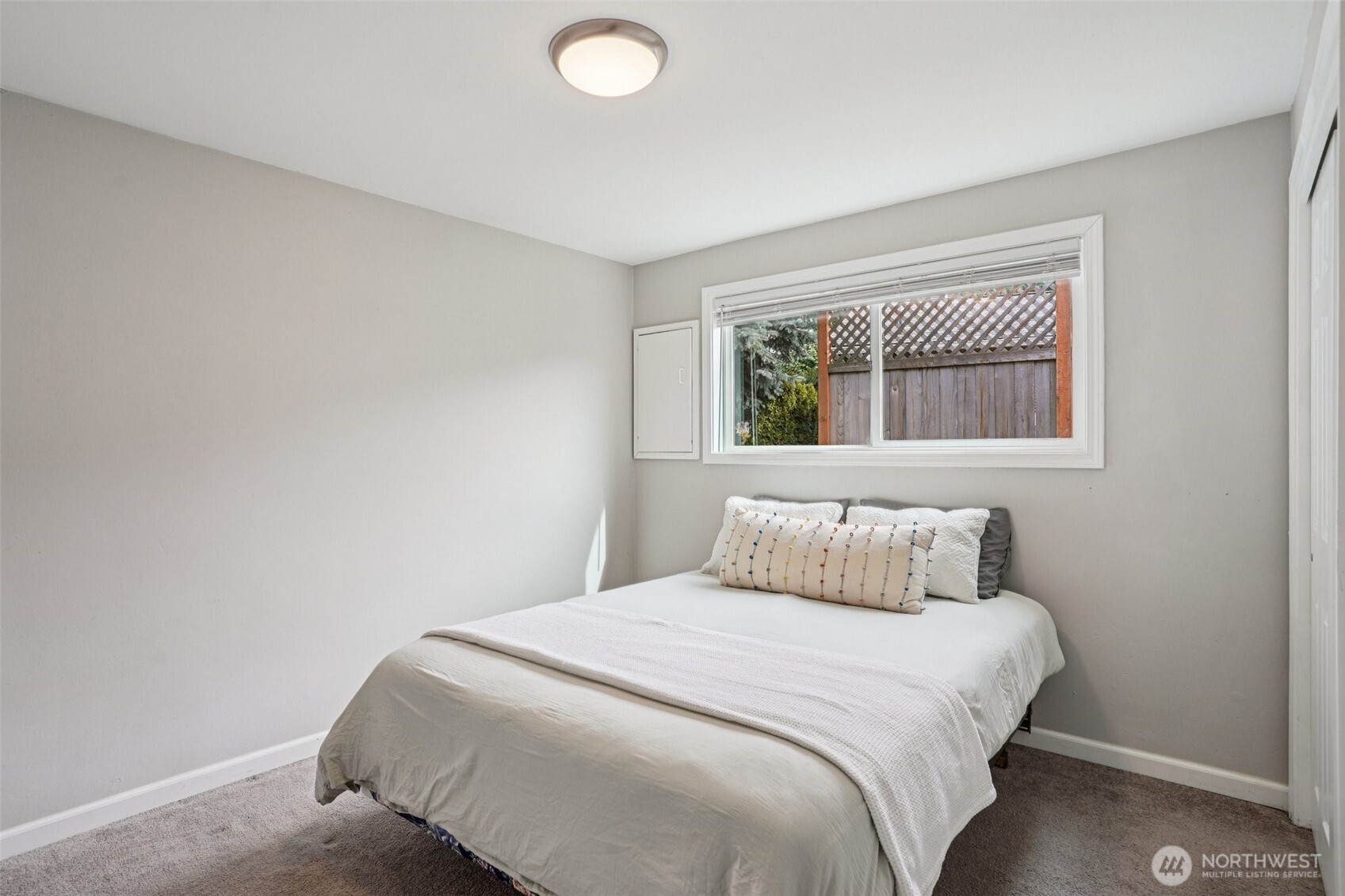 3709 Northeast 9th Court Renton, WA 98056 - Photo 10 of 21 a bedroom with a bed and windows