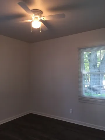 a room with a window and ceiling fan