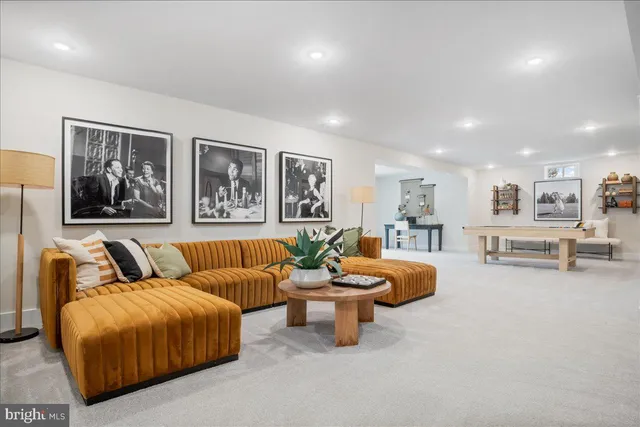 a living room with furniture and kitchen view