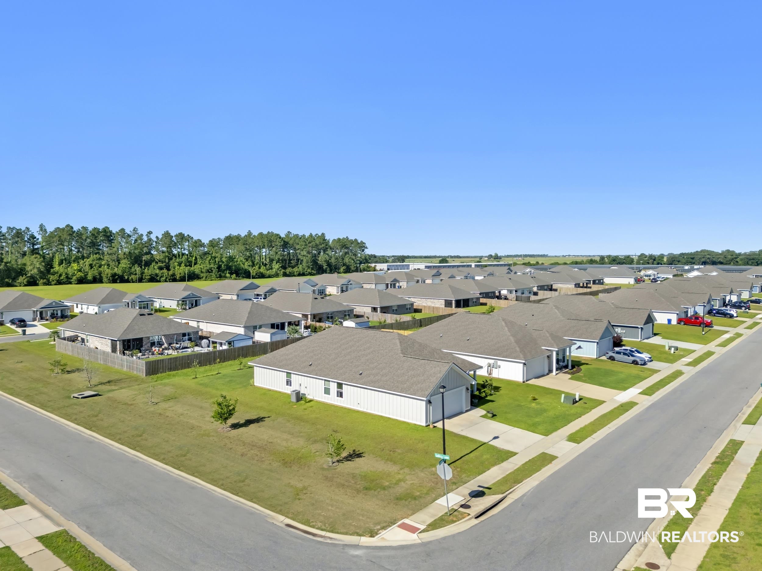 1228 Caper Avenue Foley, AL 36535 - Photo 42 of 54 Residential neighborhood featuring single-story homes with pitched roofs, front-facing garages, and a uniform aesthetic