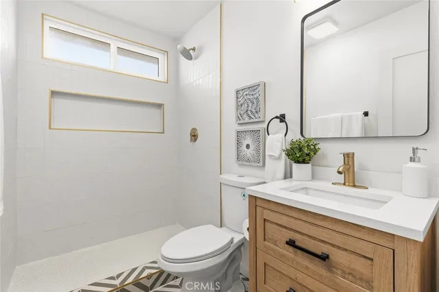 a bathroom with a sink toilet and mirror