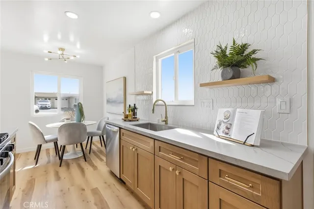 a kitchen with a sink a table and chairs