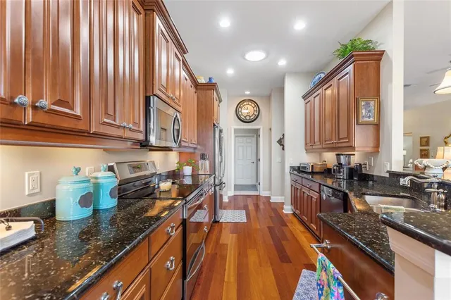 a bathroom with a sink double vanity granite tub and a mirror