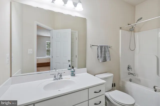 a bathroom with a sink toilet tub and shower
