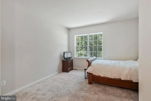a bed sitting in a room next to a window