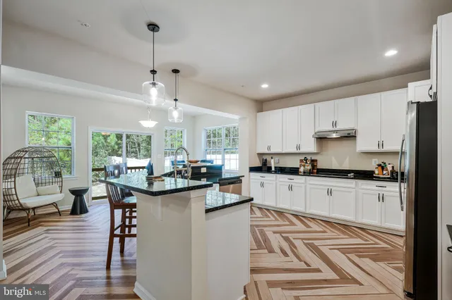 a kitchen with sink cabinets and wooden floor