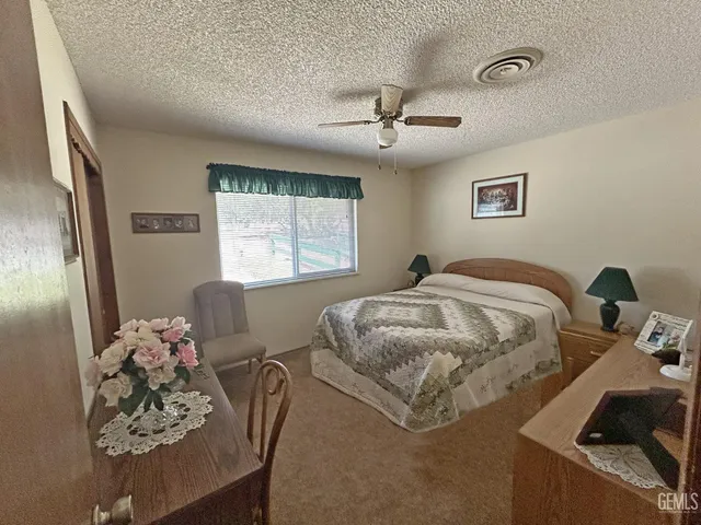 a bedroom with a bed furniture and a large window