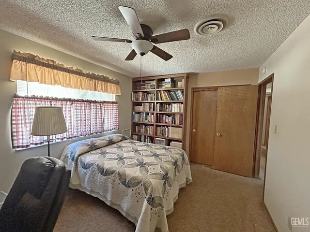a bathroom with a granite countertop sink toilet and a mirror