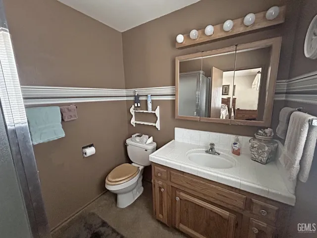 a living room with furniture and a ceiling fan