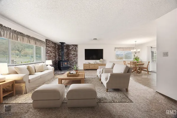 a living room with furniture wooden floor and a large window
