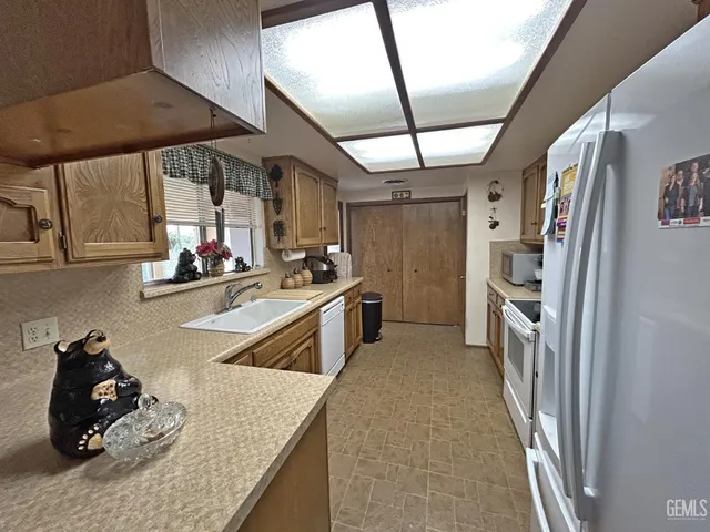 a kitchen with stove a sink and cabinets