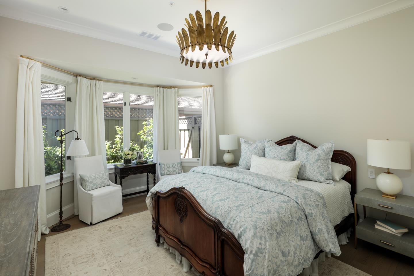 620 Morningside Circle Los Altos, CA 94022 - Photo 16 of 32 a spacious bedroom with a bed and a chandelier