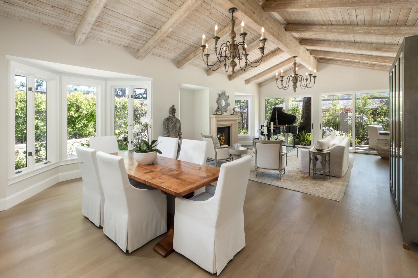 620 Morningside Circle Los Altos, CA 94022 - Photo 10 of 32 a dining room with wooden floor a chandelier a glass table and chairs