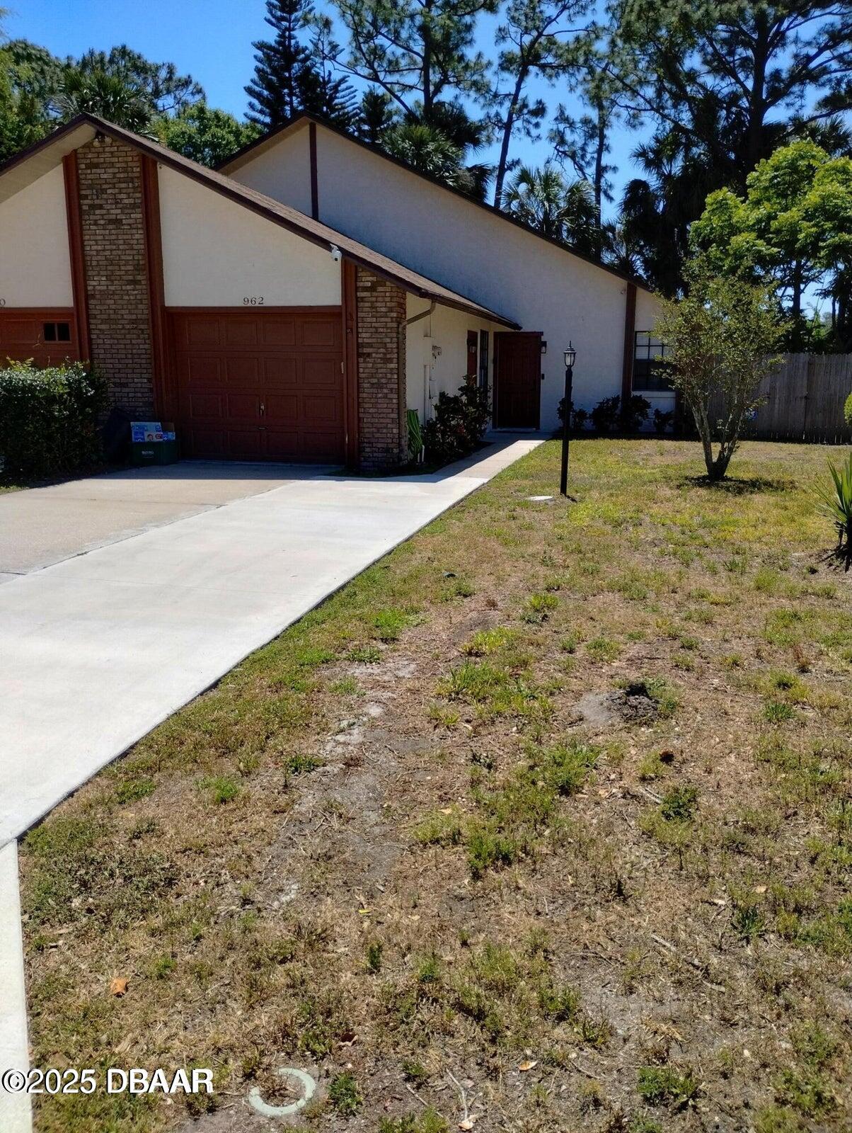 962 Stonybrook Circle Port Orange, FL 32127 - Photo 1 of 15 a backyard of a house with lots of green space