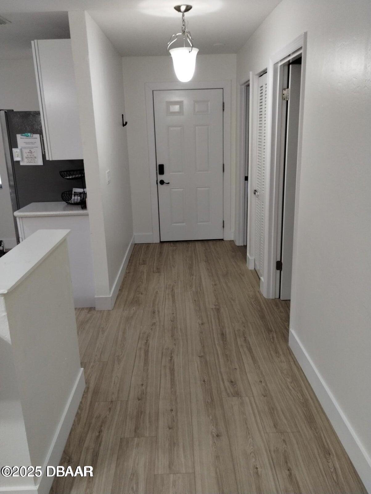 962 Stonybrook Circle Port Orange, FL 32127 - Photo 11 of 15 a view of a room with wooden floor and a ceiling fan