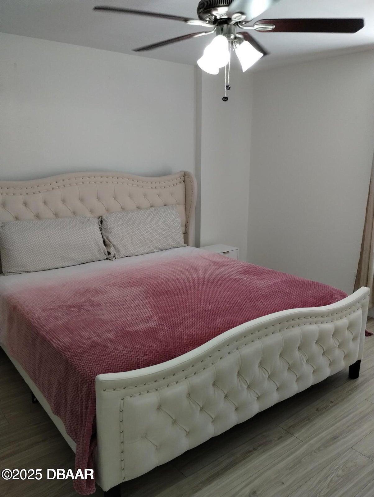 962 Stonybrook Circle Port Orange, FL 32127 - Photo 14 of 15 a bedroom with a bed and a chandelier