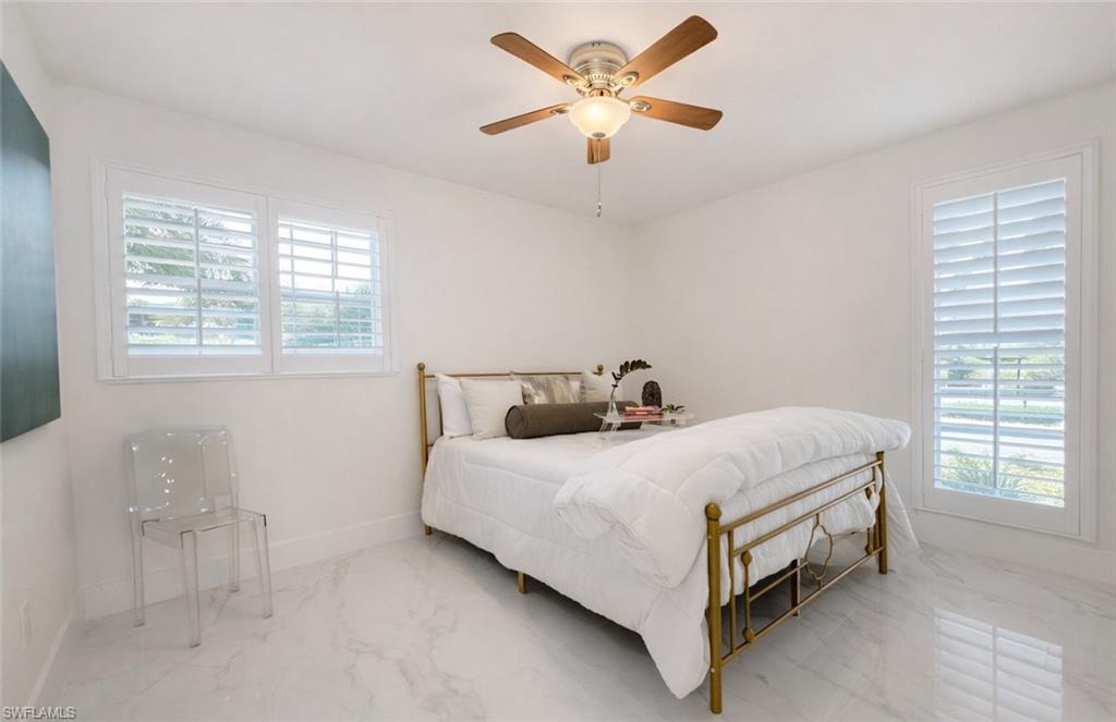 16 Knights Bridge Road Naples, FL 34112 - Photo 11 of 18 Bedroom with marble tiled flooring and a ceiling fan