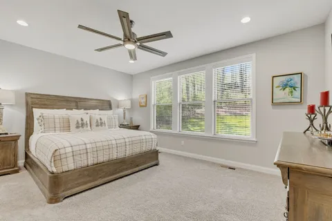 a bedroom with a bed dresser and a window