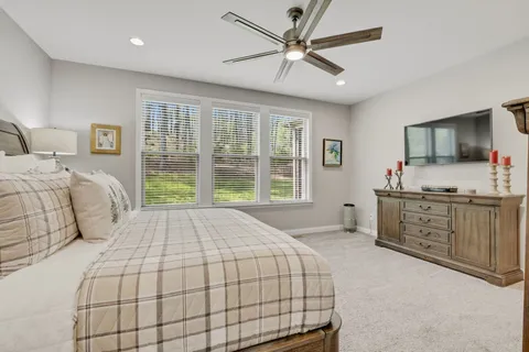 a spacious bathroom with a shower sink and mirror
