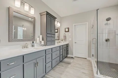 a bathroom with a tub shower and sink