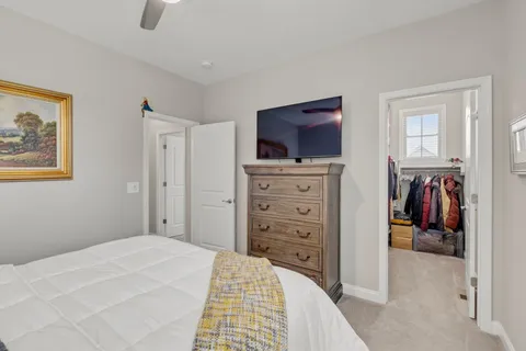 a bathroom with a granite countertop toilet sink and mirror