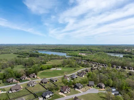 an aerial view of residential houses with lake view