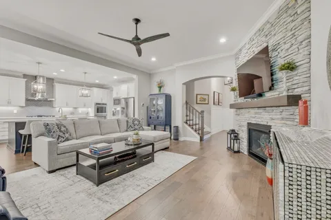 a kitchen with stainless steel appliances granite countertop a sink a stove a refrigerator and island