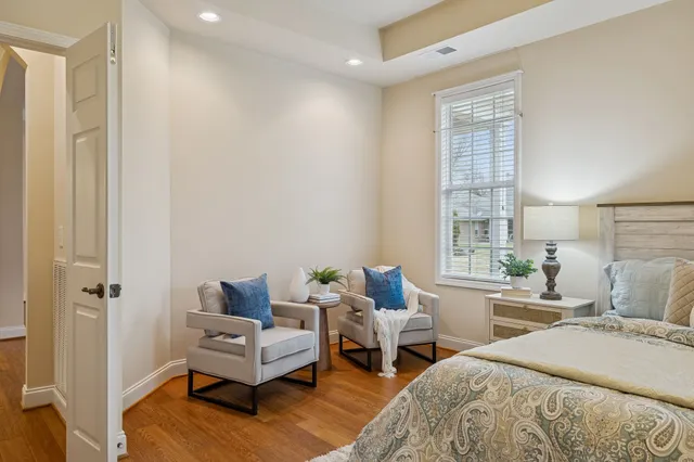 a bedroom with a large bed and a chandelier
